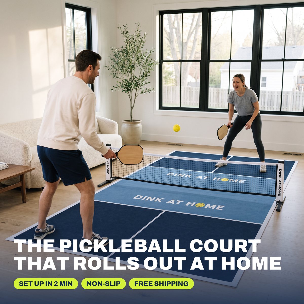 A couple playing pickleball in their living room on the Dink at Home court